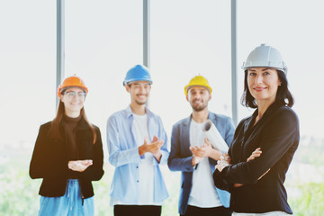 Wall Mural - Teamwork of the construction team must have quality. Whether it is engineering, construction workers. And have a helmet to wear at work. For safety at work. The team is congratulating the chief.