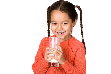 Portrait of happy cute little child girl holding glass of milk and showing white milk mustache isolated on white