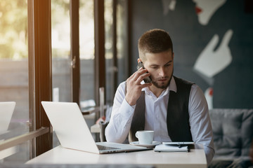 Wall Mural - Young man drawing template for the web site associated with digital marketing, current trends and tendencies of UX / UI design. Businessman who rules his company remotely, like a freelancer