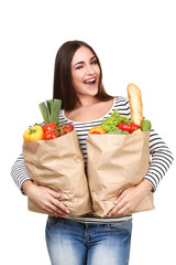 Wall Mural - Beautiful woman holding grocery shopping bags on white background