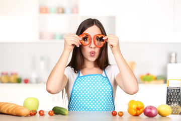 Wall Mural - Beautiful woman cooking food in the kitchen