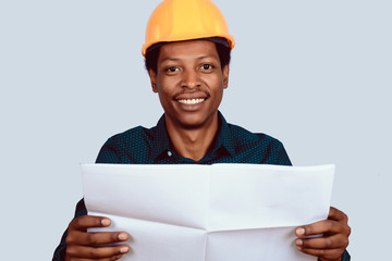 Afro american architect in hard hat with blueprint.