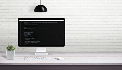 Wall Mural - computer programming on computer display with free space on brick wall for text.