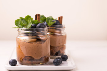 Cake dessert. Chocolate mousse with blueberry, mint and cinnamon