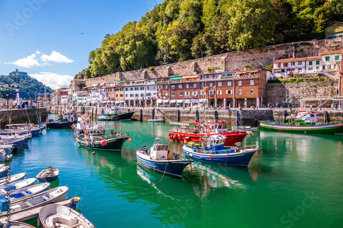 Fishing port of Donostia-San Sebastián with boats and blue sky Fototapet