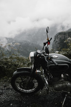 Close-up Of Black Motorcycle Parked On The Foggy Road