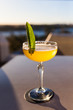© John Puah/Stocksy - Cocktail with mint leaf in sunlight