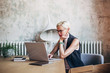 © Studio Firma/Stocksy - Businesswoman working on laptop at table