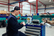 © Javier Pardina/Stocksy - Reparing an engine in the factory.