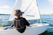 © Angela Lumsden/Stocksy - Teenage boy sailing a small dinghy