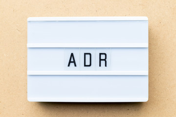 Canvas Print - White lightbox with word ADR (Abbreviation of Adverse drug reaction) on wood background