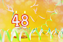 Forty Eight Years Birthday. Cupcake With Burning Candles In The Form Of Number 48. Bright Yellow Background With Copy Space