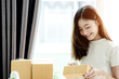 © jumlongch - Young asian girl is freelancer with her private business at home office, working with laptop, coffee, online marketing, Customer order and packaging or packing.