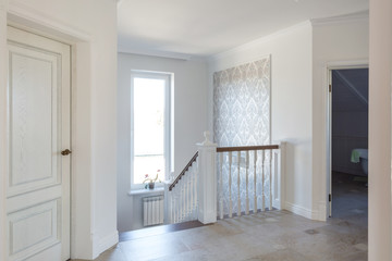 Wall Mural - wooden spiral staircase in bright interior in vacation house