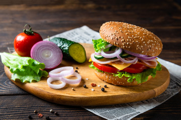 Appetizing Hamburger with ham, tomato, cucumbers, cheese and lettuce, close up