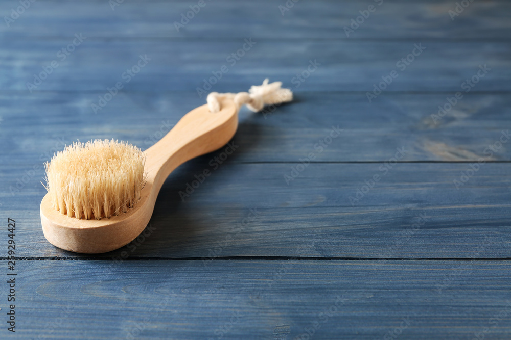 Massage brush on wooden background