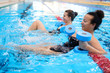 © Nejron Photo - Multiracial couple attending water aerobics class in a swimming pool