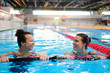 © Nejron Photo - Multiracial couple attending water aerobics class in a swimming pool