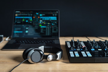 DJ tools for creating electronic music on a wooden table