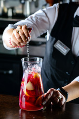 Sticker - Bartender making Red Sangria in Italian restaurant. Sangria cocktail with red wine