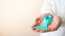 Teal Ribbon Awareness On Female Hands In White T-shirt. Symbolic For Cervical Cancer, Ovarian Cancer, Gynecological Cancer And PCOS. Women's Health Care Concept. Copy Space.