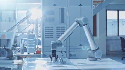Leinwandbilder - In the Bright Robotic Industry Engineering Facility Robot Arm Picks Up Metal Component Moves it Into Place. Tech Industrial Technology Using Modern Machine Learning, Neural Networking for Efficiency.