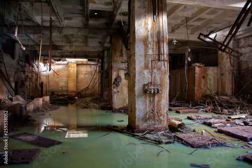 Flooded collapsed basement of abandoned industrial building