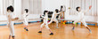 © JackF - Adults and teens wearing fencing uniform practicing with foil