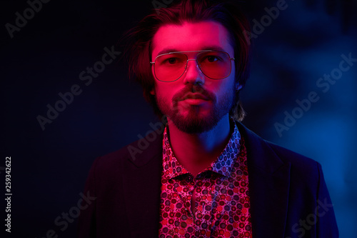 Neon Light Portrait Of Handsome Male Model With Dark Medium Length