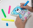 Leinwandbild Motiv Children's hands coloring toy bear with watercolor pens