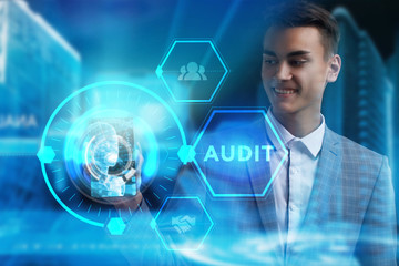 The concept of business, technology, the Internet and the network. A young entrepreneur working on a virtual screen of the future and sees the inscription: Audit