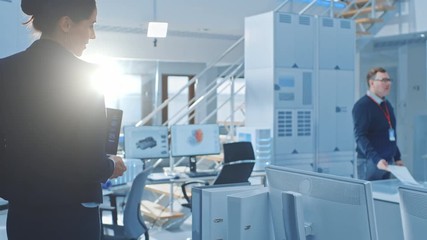 Aufkleber - Following Slow Motion Shot of Stylish Female Engineer Holding Laptop Computer with Cloud Computing on Screen, Enters Bright Modern Facility and Joins Her Team of Specialists. Modern Research Facility