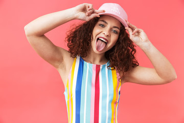 Canvas Print - Portrait of a cheerful young woman wearing cap