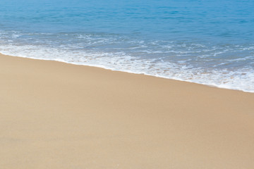 Soft wave of sea and sandy beach background.