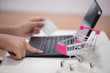 © sap - hands holding a credit card and using laptop for online shopping