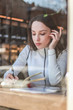 © Yaroslav - Portrait of a pretty young business lady working in a cafe. Papers, telephone conversations, laptop and coffee in the coworking area