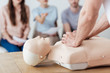 © LIGHTFIELD STUDIOS - cropped view of instructor performing chest compression on dummy during cpr training class
