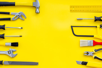 Wall Mural - instruments of constructor for build, paint and repair house on yellow background top view mockup