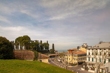 Wall Mural - High angle view of Peschiera del Garda, an ancient town on the shore of Lake Garda in the province of Verona, in a sunny spring day, Veneto, Italy