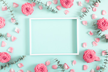 Wall Mural - beautiful flowers composition. blank frame for text, pink rose flowers, eucalyptus leaves on pastel 