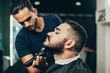 © kleberpicui - Client during beard and hair grooming in barber shop