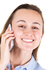 Wall Mural - portrait closeup of young smiling woman with mobile phone looking up