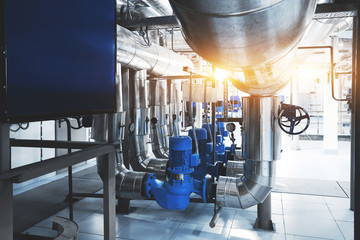 Wall Mural - boiler room with pumps and pipe lines supplying steam with pressure gauges installed Blue toning with sunflare