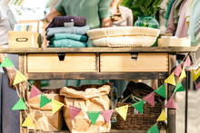 Colorful Flags, Craft Paper Bags And Goods For Garage Sale On The Summer Vintage Festival Market
