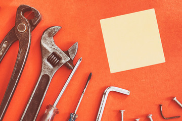 Wrench engineer constructor tools on a denim workers, A red background with engineer constructor tools. Several engineer constructor tools on a denim workers. Set of engineer hand tools for background