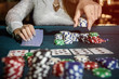© RomanR - Female hands with playing cards and poker chips