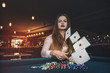 © RomanR - Beautiful woman in casino throwing playing cards