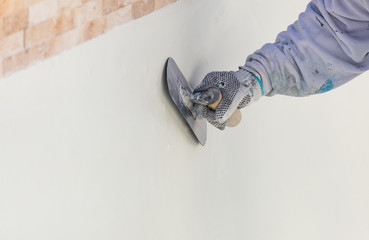 Wall Mural - Worker Smoothing Wet Pool Plaster With Trowel