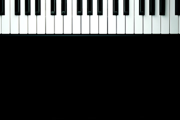 Black background with piano keys close up