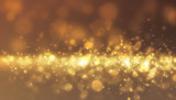 Fototapeta Kosmos - Gold glitter light flowing from side scene with soft light on gold backgrpund